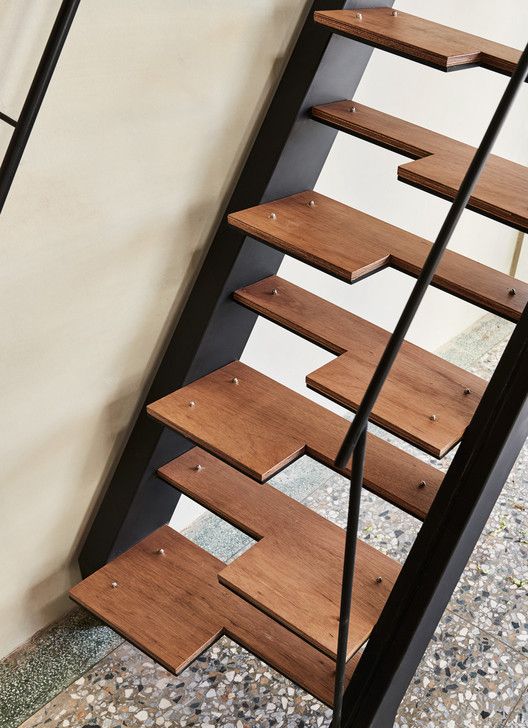 a set of wooden stairs next to a wall