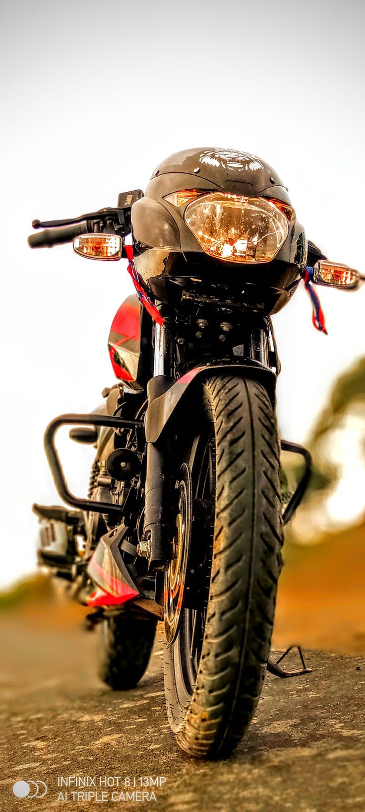 a motorcycle parked on top of a dirt road