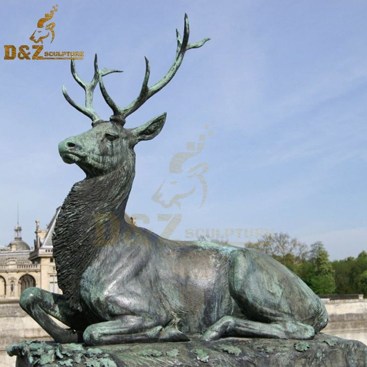 a statue of a stag sitting in front of a building