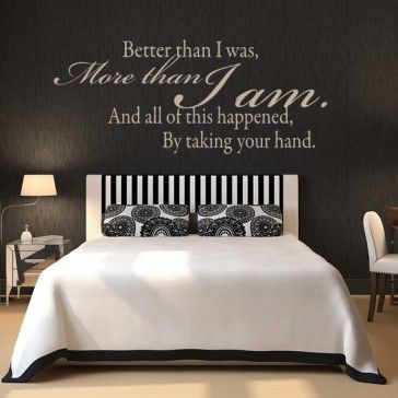 a bedroom with a bed, chair and wall decal that says it's all in the way you travel the world