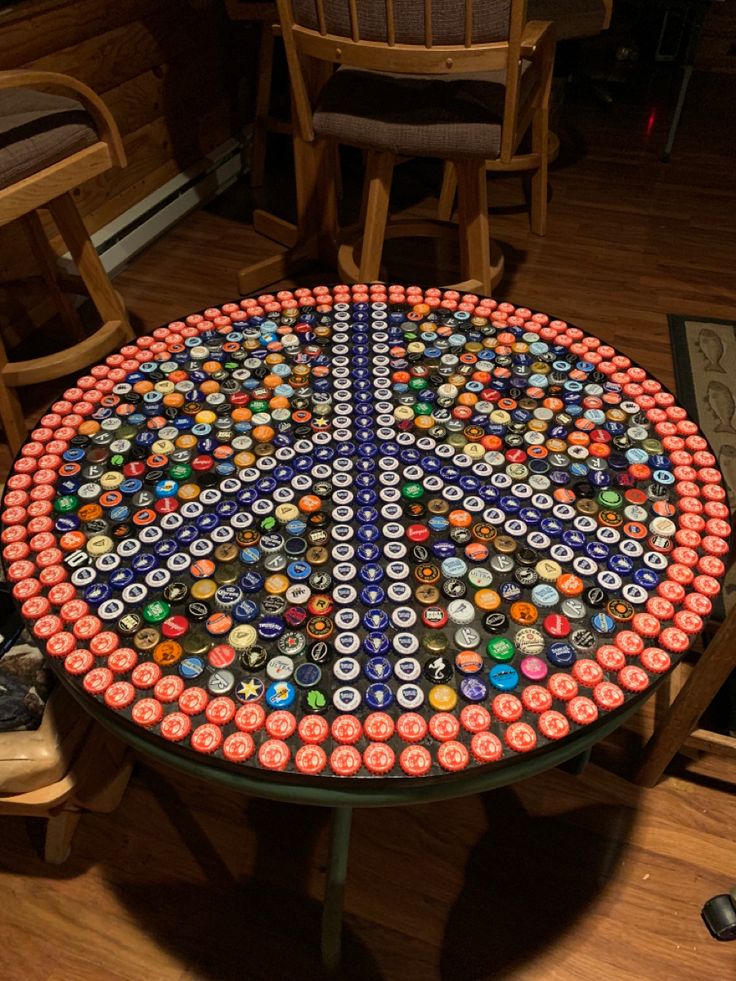 a table made out of beer cans on top of a wooden floor