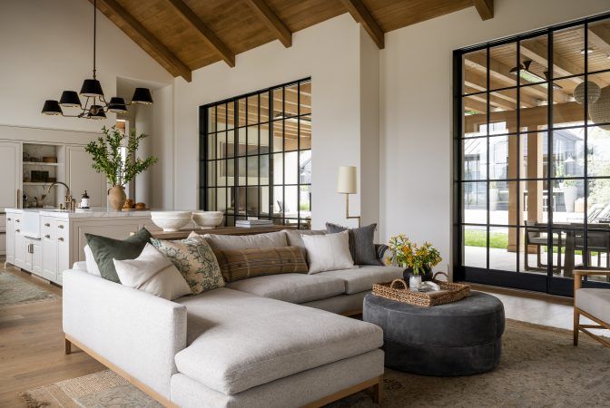 a living room filled with furniture and lots of windows