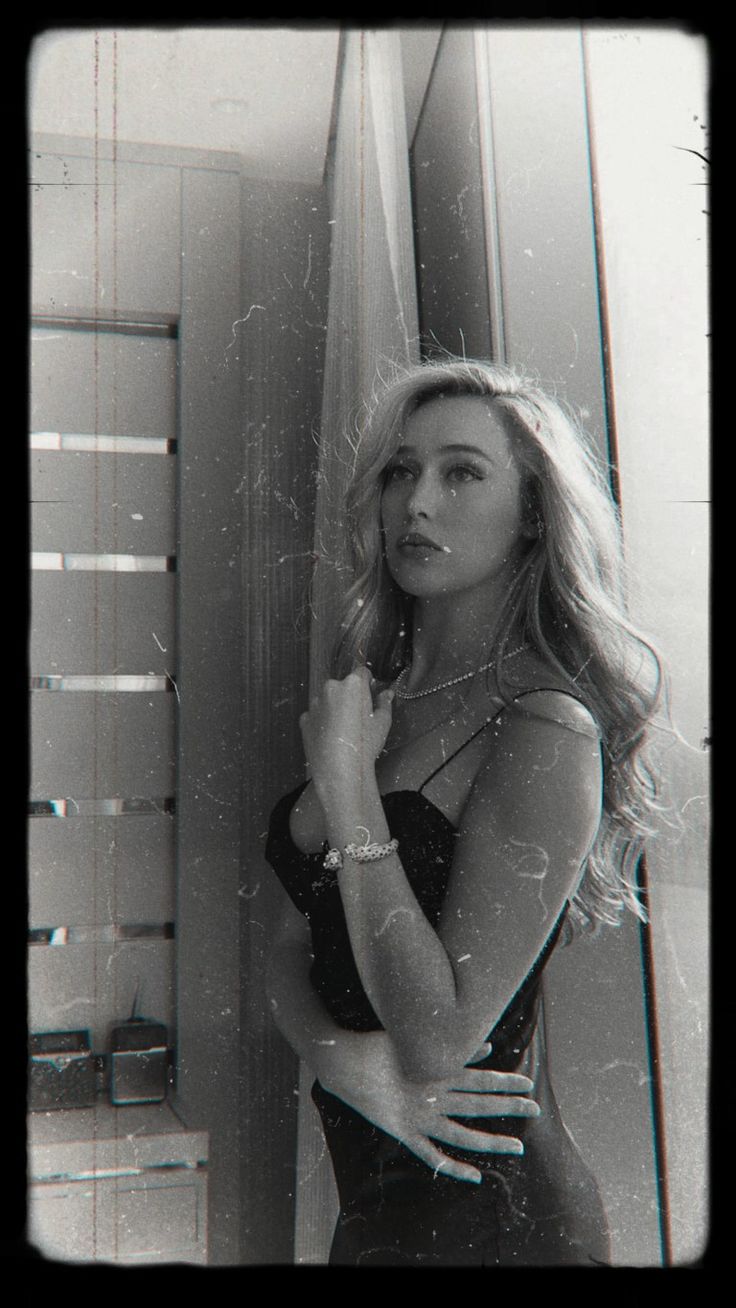 a black and white photo of a woman brushing her teeth