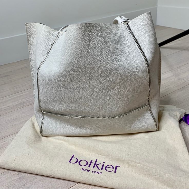 Nwot. Botkier Soho Bite Size Leather Tote Bag Un Off White. 100% Leather Chunky Decorative Zips Bring An Industrial Edge To This Botkier Tote. Raw Top. Metallic Interior With 2 Pockets. Double Handles. Dust Bag Included. Leather: Cowhide. Weight: 38oz / 1.08kg. Imported, Us Measurements Height: 12.5in / 32cm Length: 18in / 46cm Depth: 5.5in / 14cm Handle Drop: 9in / 23cm White Chic Calf Leather Shoulder Bag, Chic White Calf Leather Shoulder Bag, White Calf Leather Shoulder Bag With Double Handle, White Calf Leather Tote Bag, White Calf Leather Shoulder Bag With Removable Pouch, White Calf Leather Shoulder Bag With Soft Leather, White Calf Leather Shoulder Bag For Daily Use, White Calf Leather Bag For Everyday Use, White Calf Leather Satchel Shoulder Bag