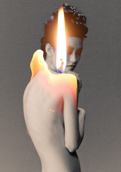 a man holding a lit candle in his hand