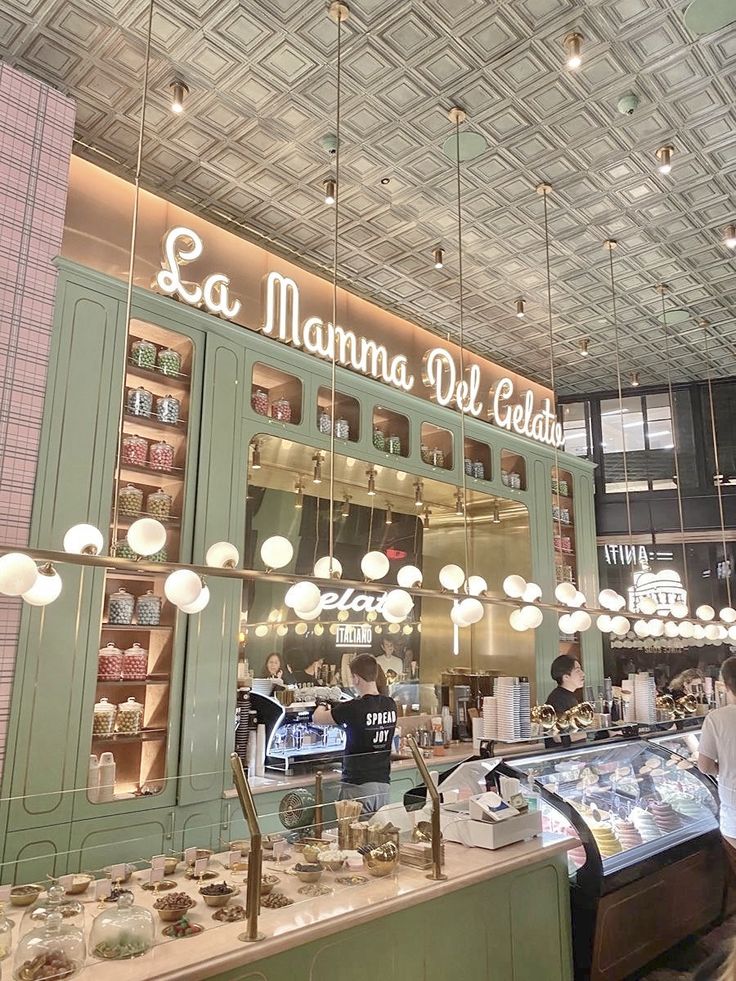 the interior of a deli restaurant with green cabinets and lights hanging from the ceiling