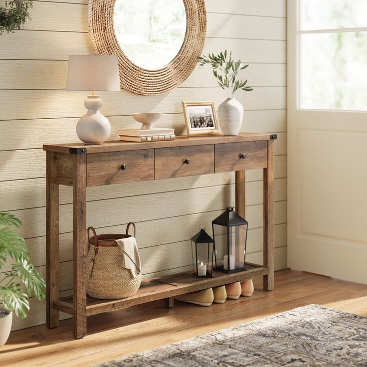 a wooden table sitting in front of a mirror on top of a hard wood floor