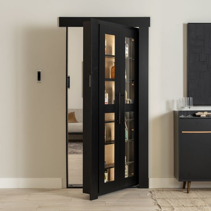 a tall black cabinet sitting in the corner of a room