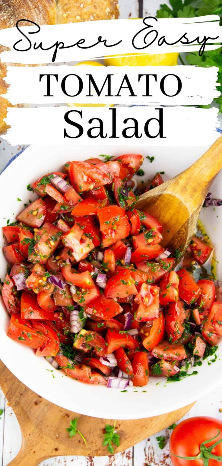 a white bowl filled with tomato salad next to bread and tomatoes on a cutting board