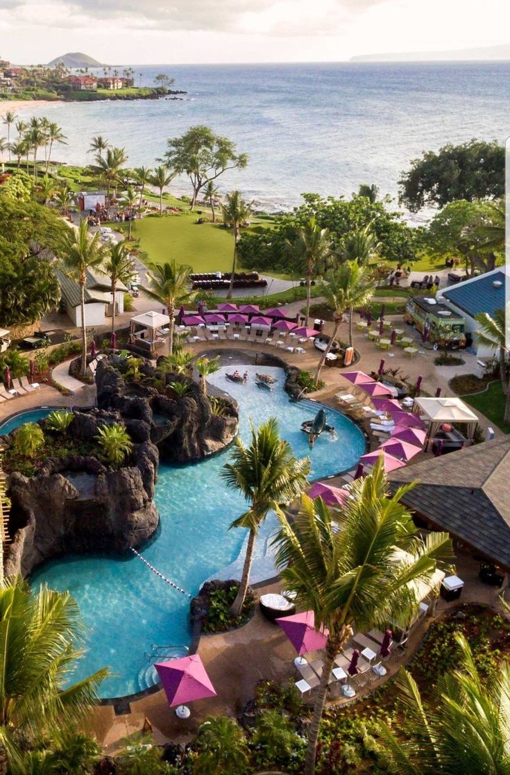 an aerial view of a resort pool and beach