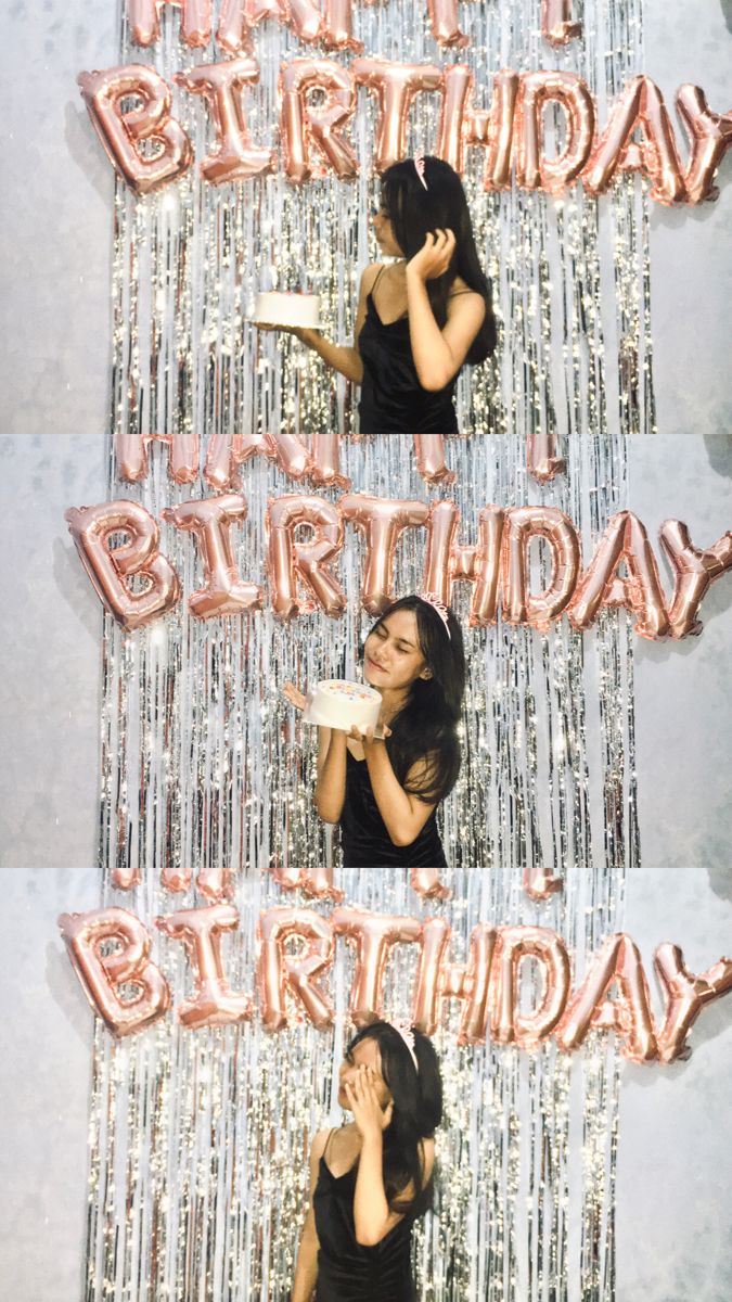 a woman sitting in front of a happy birthday sign