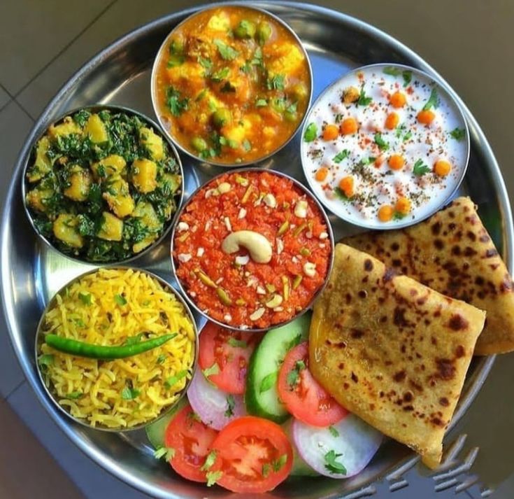 a metal plate topped with different types of food