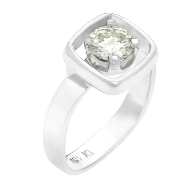 a white gold ring with an oval cut diamond in the center, set on top of a