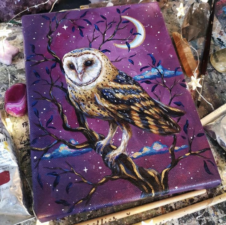 an owl is sitting on a tree branch painted with acrylic paint