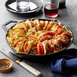 lobsters and rice in a skillet on a table