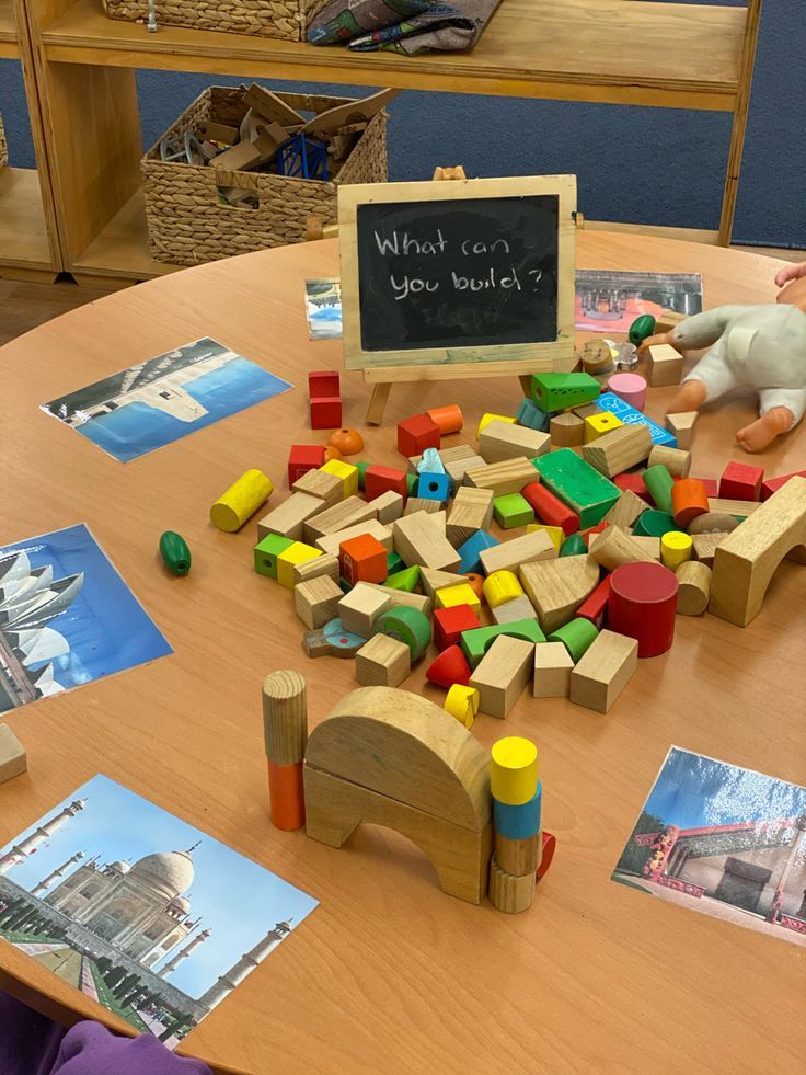 a wooden table topped with lots of different colored blocks and toys on top of it