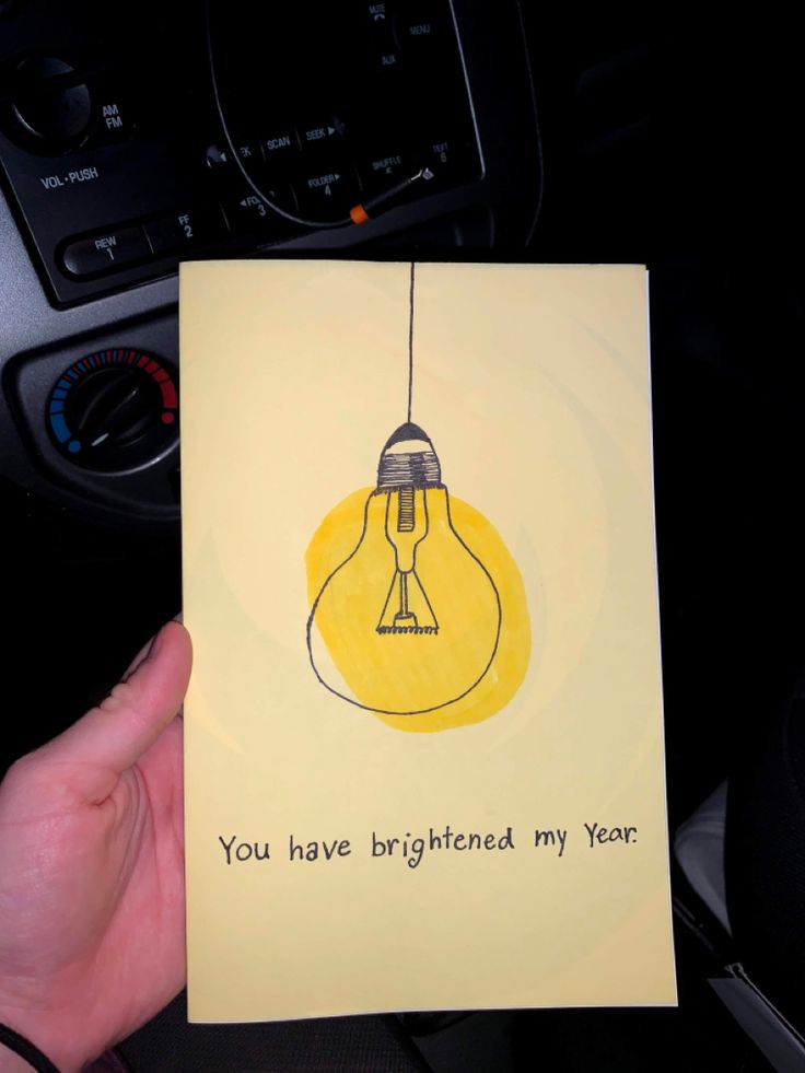 someone holding up a card that says, you have brighter my year