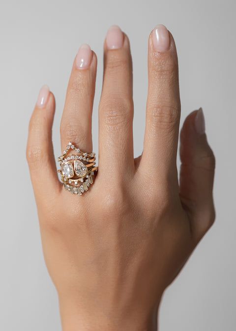 a woman's hand with two rings on it