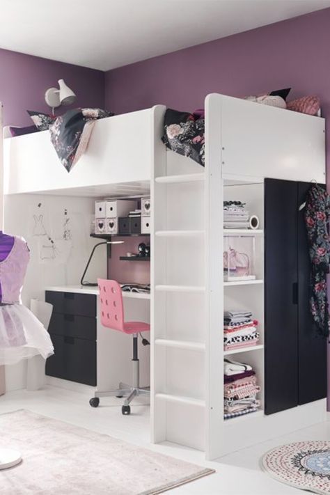 a white loft bed sitting next to a desk and chair in a room with purple walls