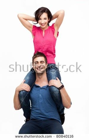 a man sitting on top of a woman's shoulders