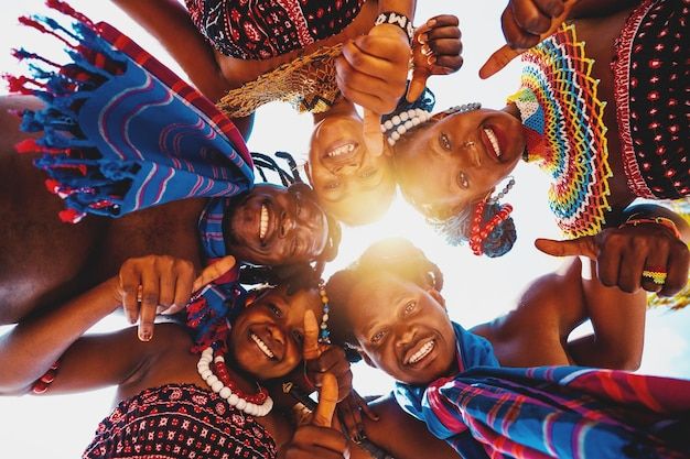 a group of people standing in a circle with their hands on each other's shoulders