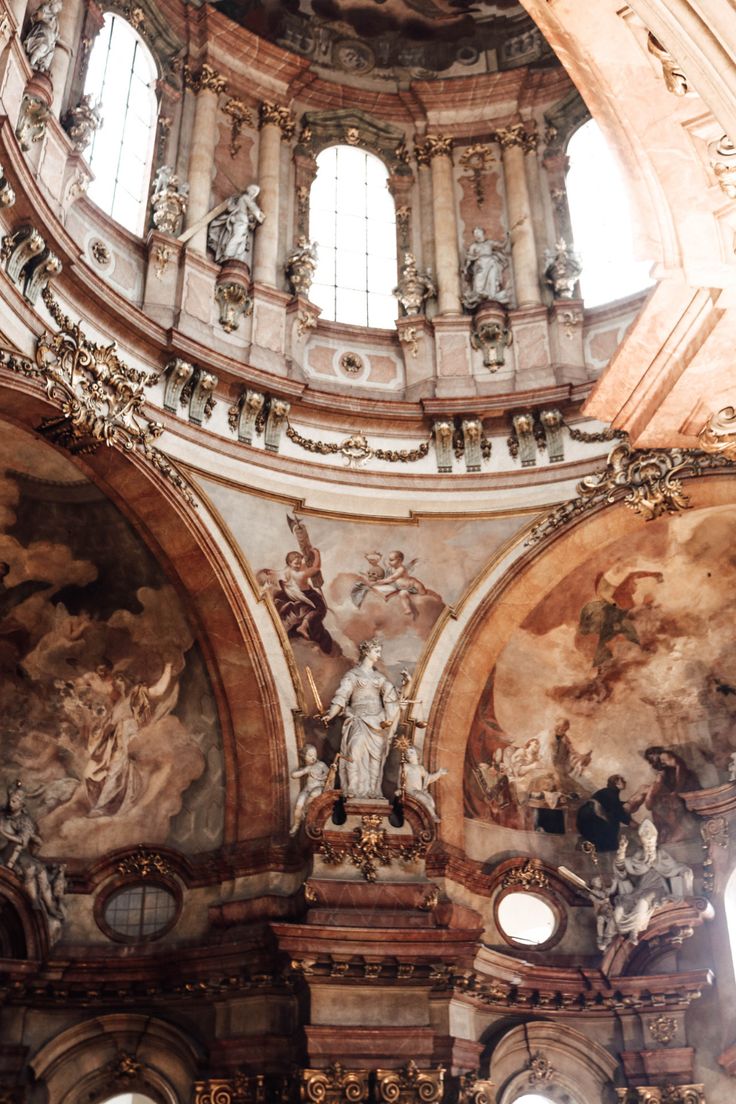 the inside of an old church with paintings on the walls