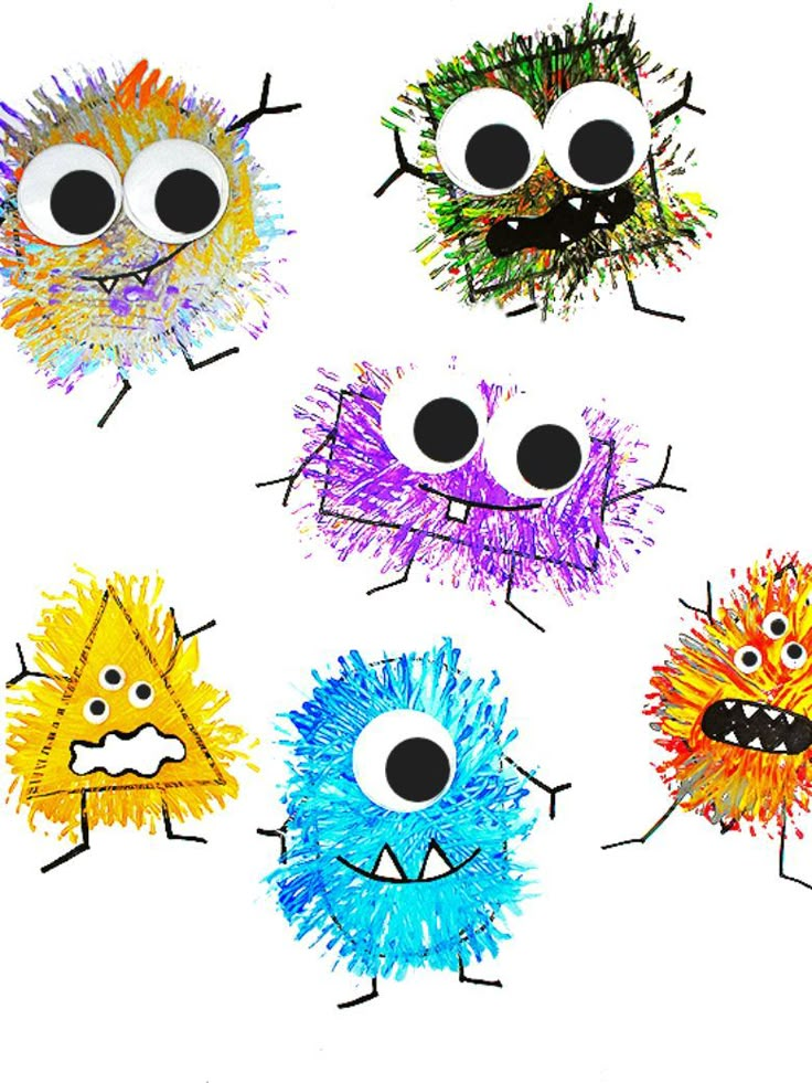 four different colored paper monsters with black eyes and one is drawn in the shape of a face