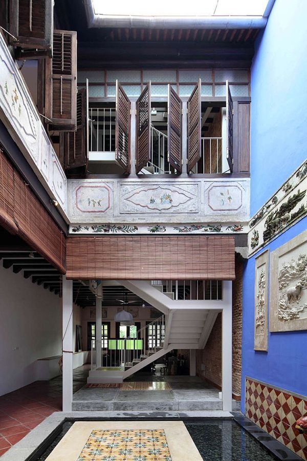 the inside of an old building with tiled floors and stairs on either side of it