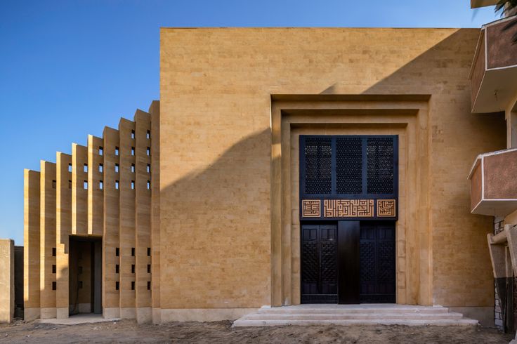 an entrance to a building with wooden slats on the outside and doors in front