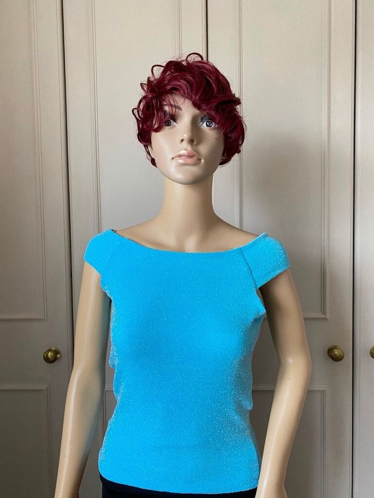 A beautiful knitted sleeveless top in a frosty sky blue colour. It can be worn on or off the shoulder.  This top is fully lined, and medium weight and ideal for holding shape. A very glamorous looking top which looks good with dance trousers and will dress up plain trousers, jeans or leggings Measurements  One only available in small to medium size Bust 80-104cm Waist 66-96 Hips 76-106cm Length 52cm This garment can fit more than one size. If you have the smaller measurements this will be a loos Fitted Sleeveless Crop Top For Evening, Off-shoulder Stretch Tank Top For Party, Stretchy Off-shoulder Tank Top For Party, Fitted Off-shoulder Crop Top For Party, Stretch Off-shoulder Tank Top For Party, Blue Off-shoulder Party Blouse, Stretch Knit Top For Evening, Fitted Knit Off-shoulder Top, Stretch Sleeveless Knit Top For Party