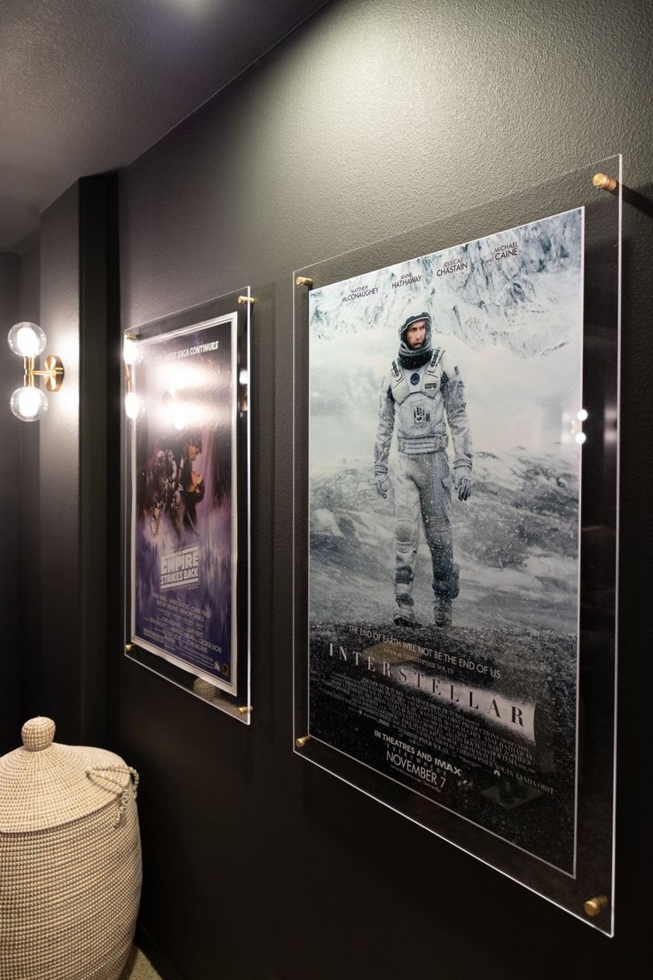 two framed movie posters hang on the wall