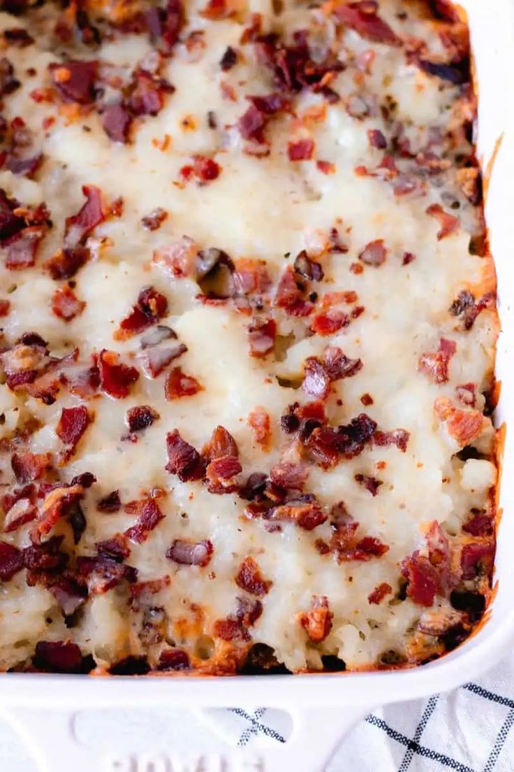 a casserole dish filled with cheese and bacon