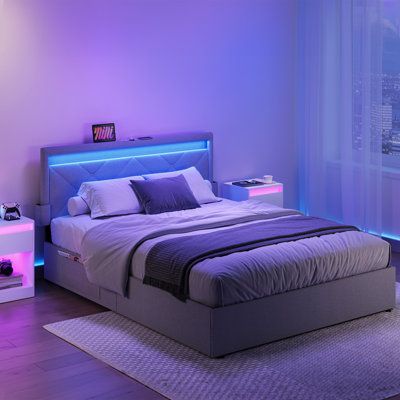 a bedroom with purple lighting and a large bed