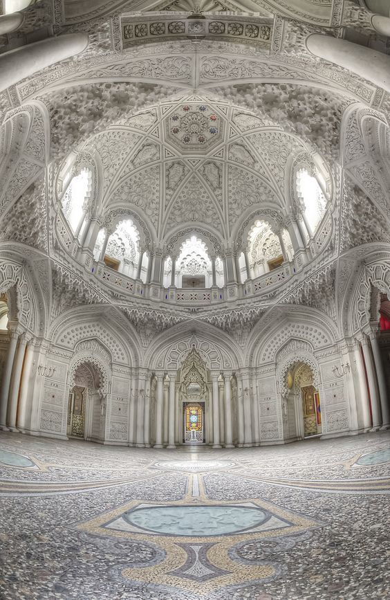 the inside of an ornate building with arched windows and arches on the ceiling is shown