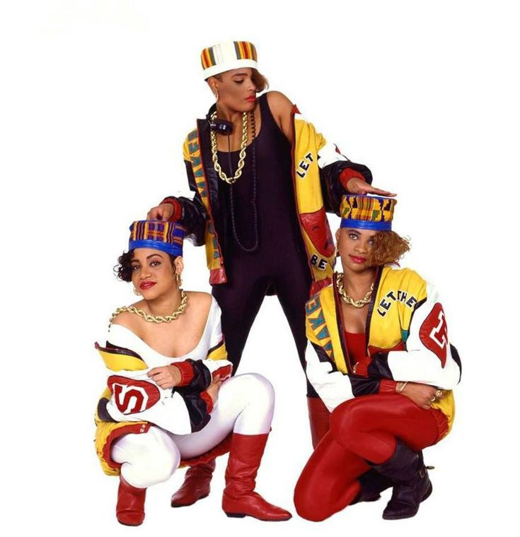 three people dressed in costume posing for a photo together on a white background with one person wearing red pants and the other woman is wearing yellow