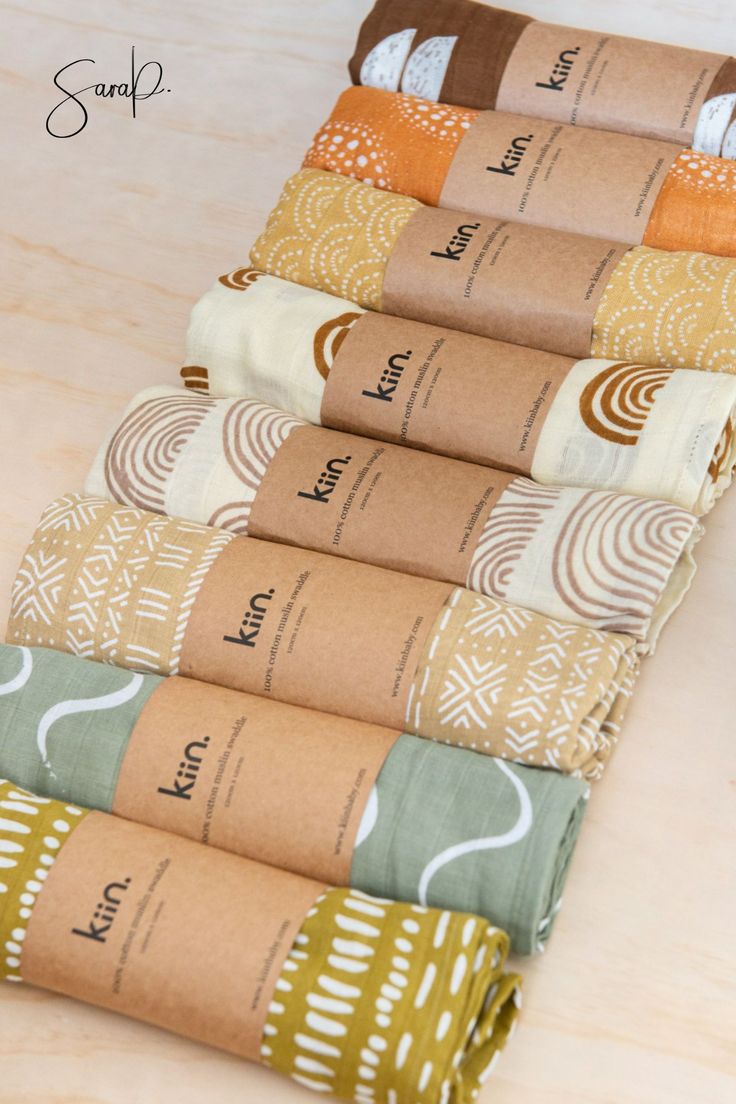 the rolled up papers are lined up on the counter top with different colors and patterns