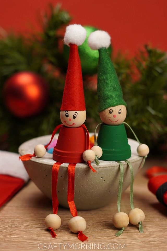 two little elfs are sitting in a bowl