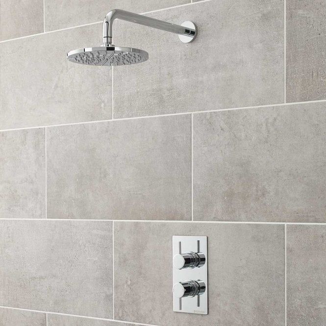 a shower head with thermostaer and hand held shower faucet in grey tile