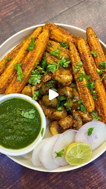 a white plate topped with french fries next to green sauce and sliced onion wedges