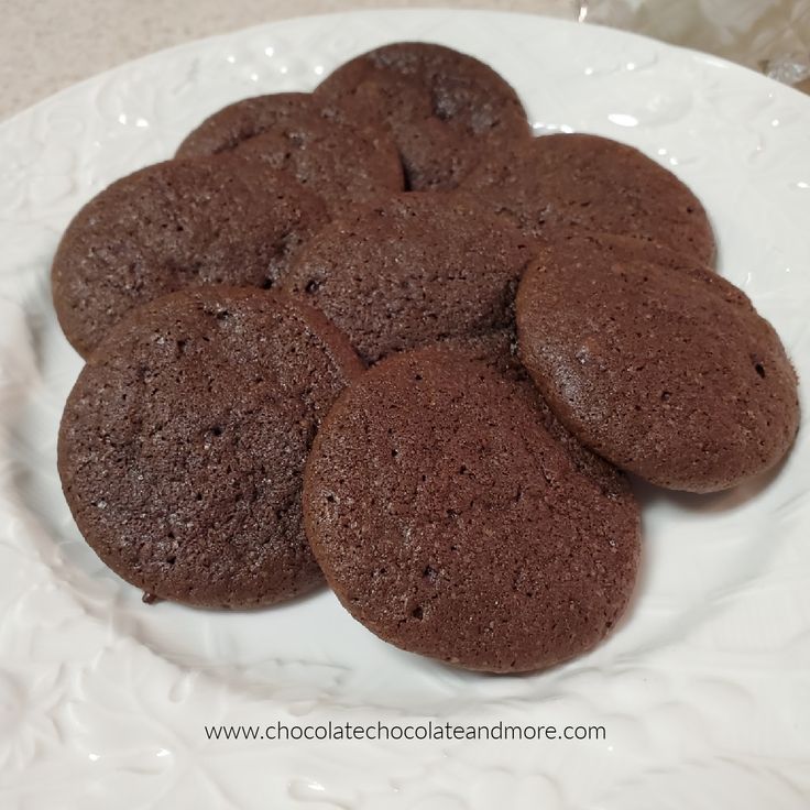 chocolate cookies are arranged on a white plate