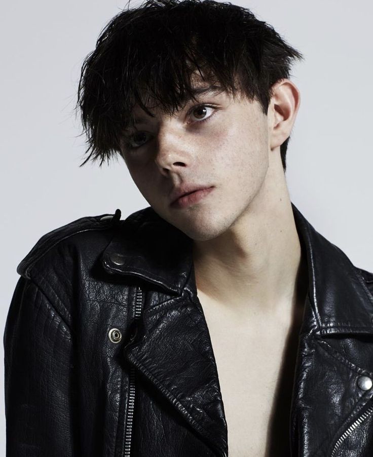 a young man wearing a black leather jacket