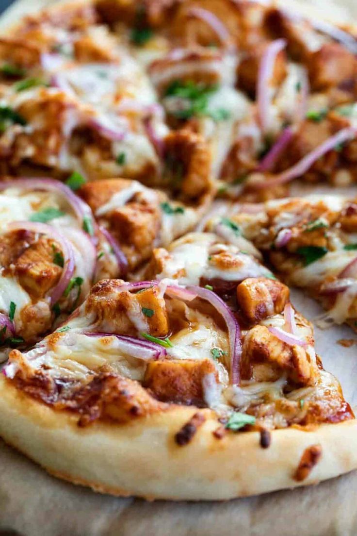 a pizza with chicken and onions on it