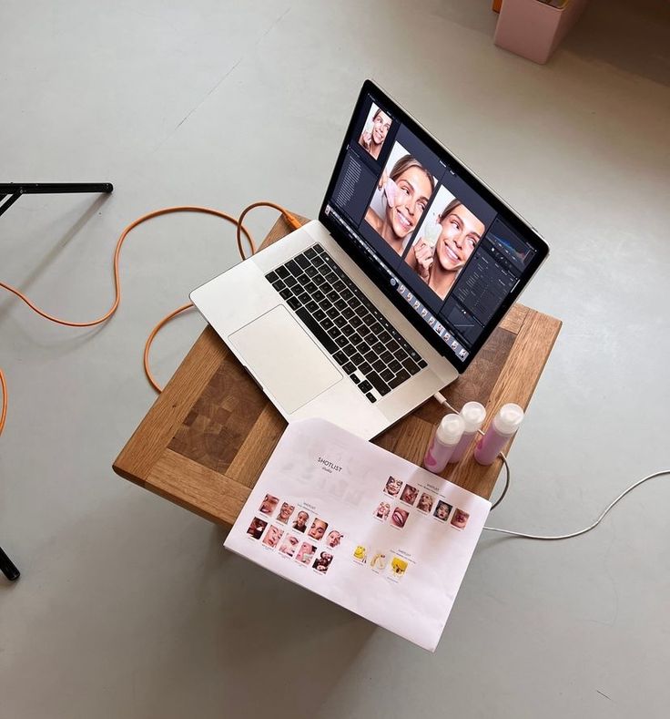 an open laptop computer sitting on top of a wooden table