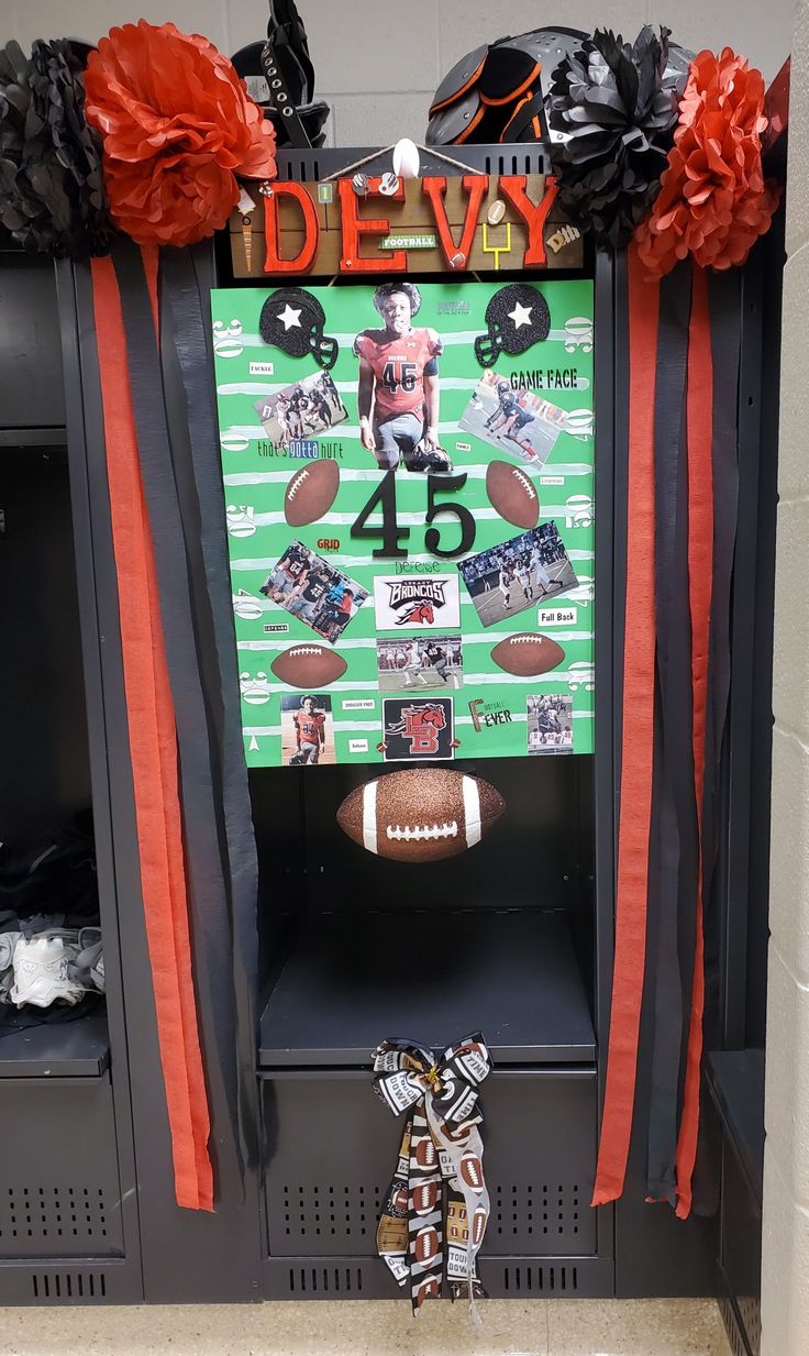 a football themed locker with red and black decorations on it, along with an orange ribbon