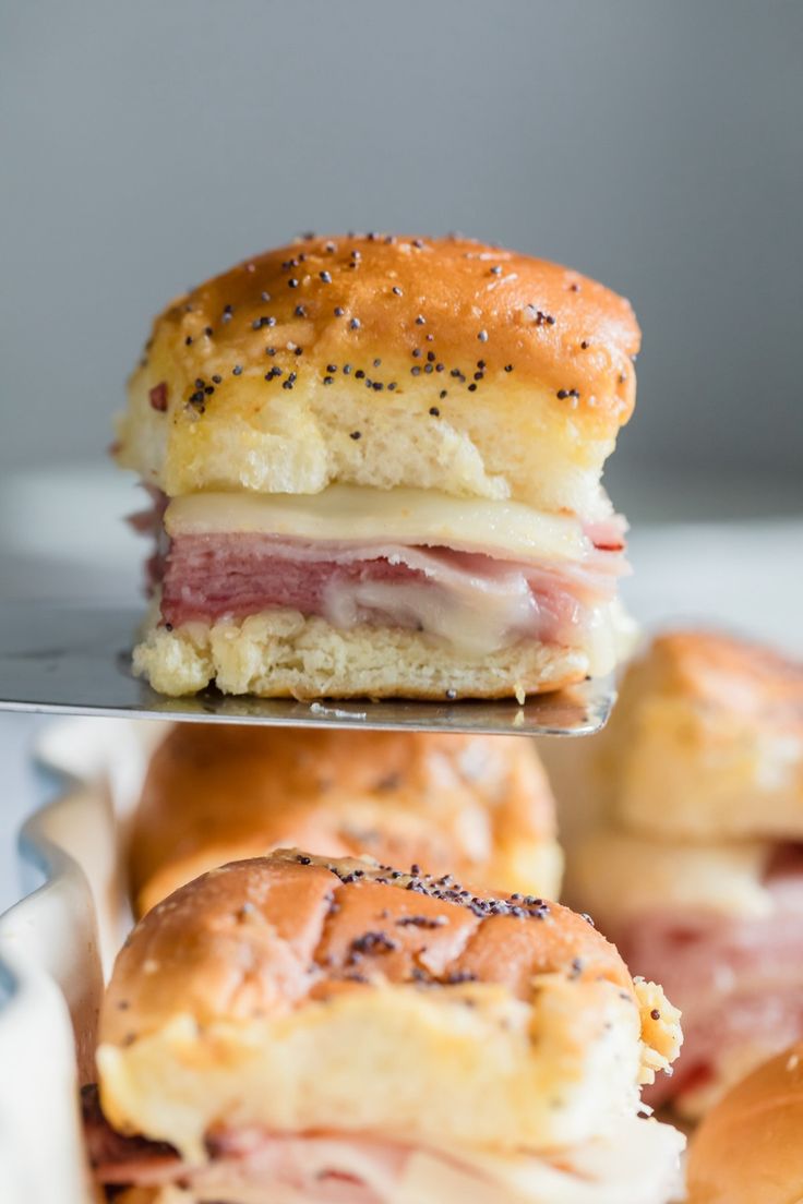 ham and cheese sliders with poppy seed sprinkles on the buns