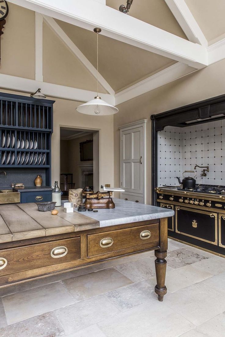 an old fashioned kitchen with blue cabinets and marble counter tops is pictured in this image