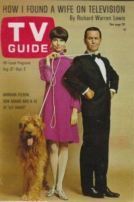 an old tv guide with a man and woman in formal attire holding a dog on a leash