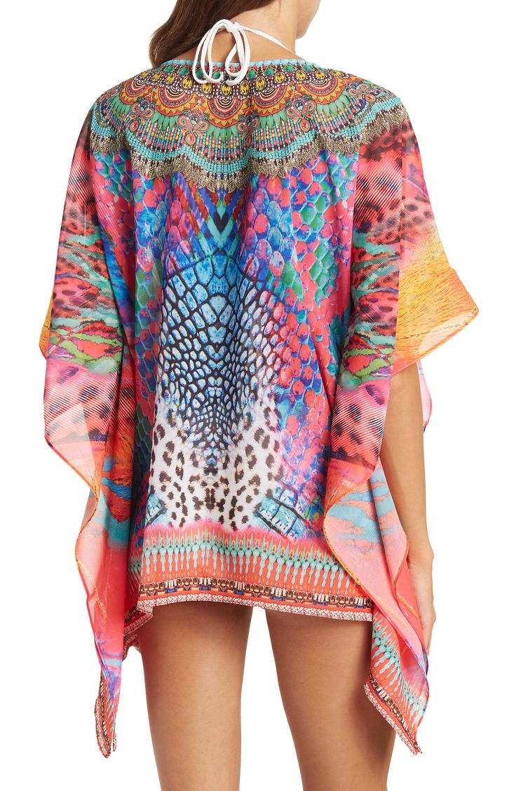 Unleash your free boho spirit in this poncho styled with vivid allover patterns and beaded embellishments. 28'' length (OS) V-neck Kimono sleeves All-over print Woven 100% polyester Dry clean Imported Model stats: 5'10", 32" bust, 25" waist, 36" hip. Model is wearing size OS. Bohemian Multicolor Tunic Cover-up, Bohemian Multicolor Print V-neck Kaftan, Multicolor Poncho For Beach Cover-up In Summer, Casual Multicolor Boho Print Cover-up, Multicolor Printed Cover-up With Kimono Sleeves, Bohemian Multicolor Printed Cover-up, Multicolor Boho Print Kaftan With Kimono Sleeves, Hippie Multicolor Poncho For Beach, Bohemian Multicolor Poncho For Festival