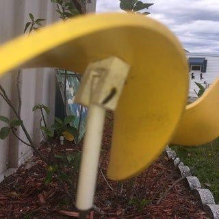 a yellow object sticking out of the ground