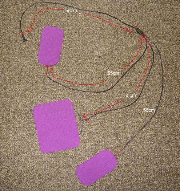 two pieces of purple paper with red wires attached to them on the floor next to each other